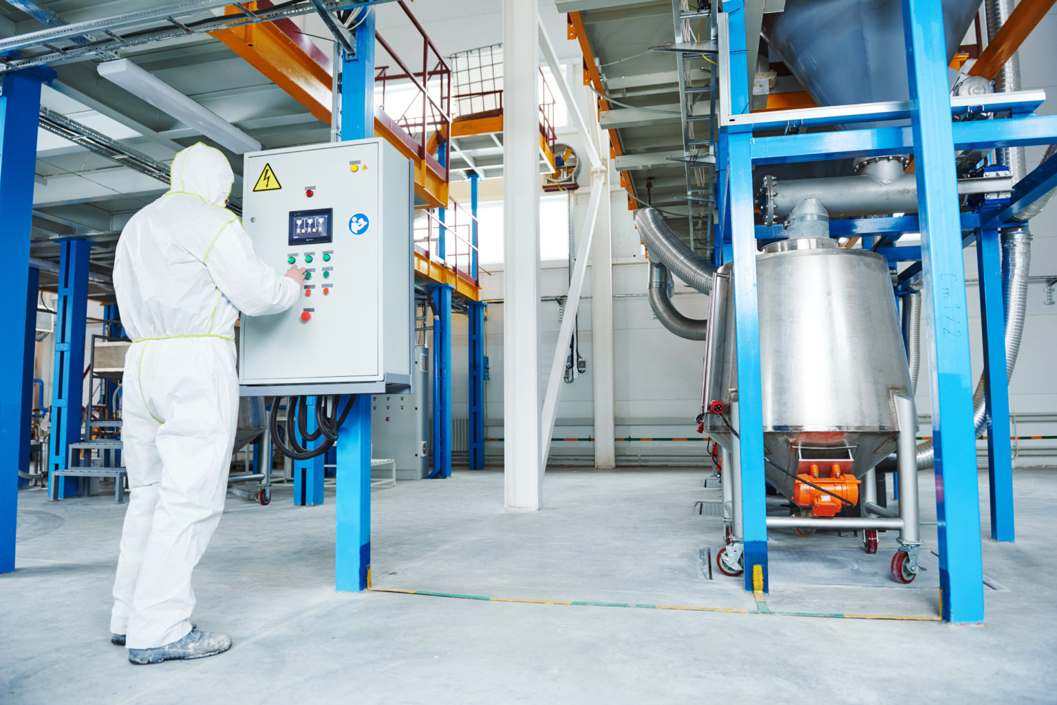 chemical industry worker operating equipment at technological industrial factory